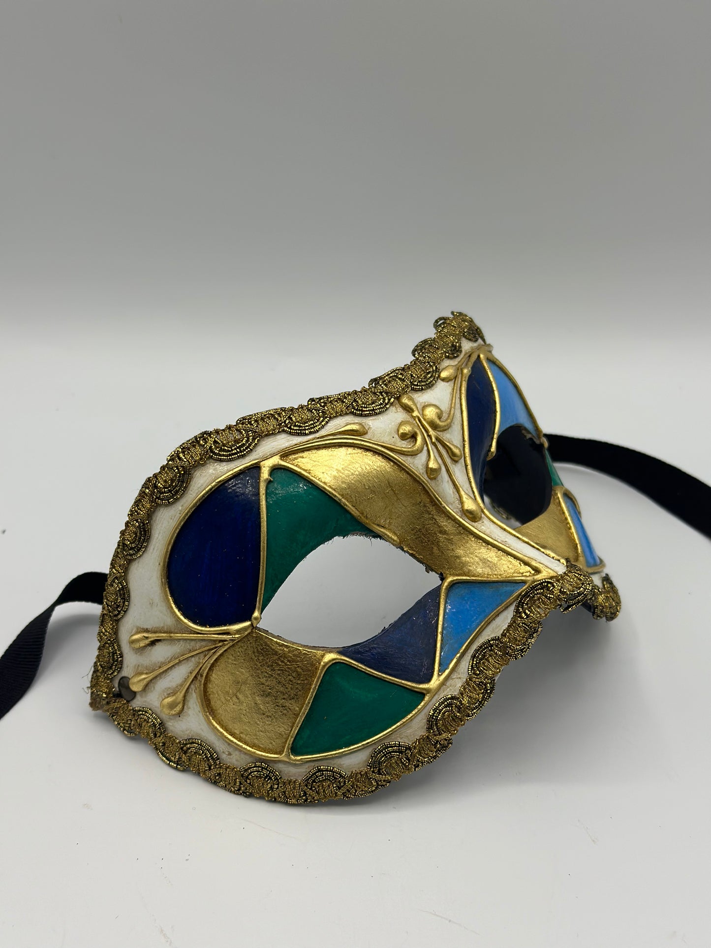 Masquerade mask in beautiful colours with golden trim